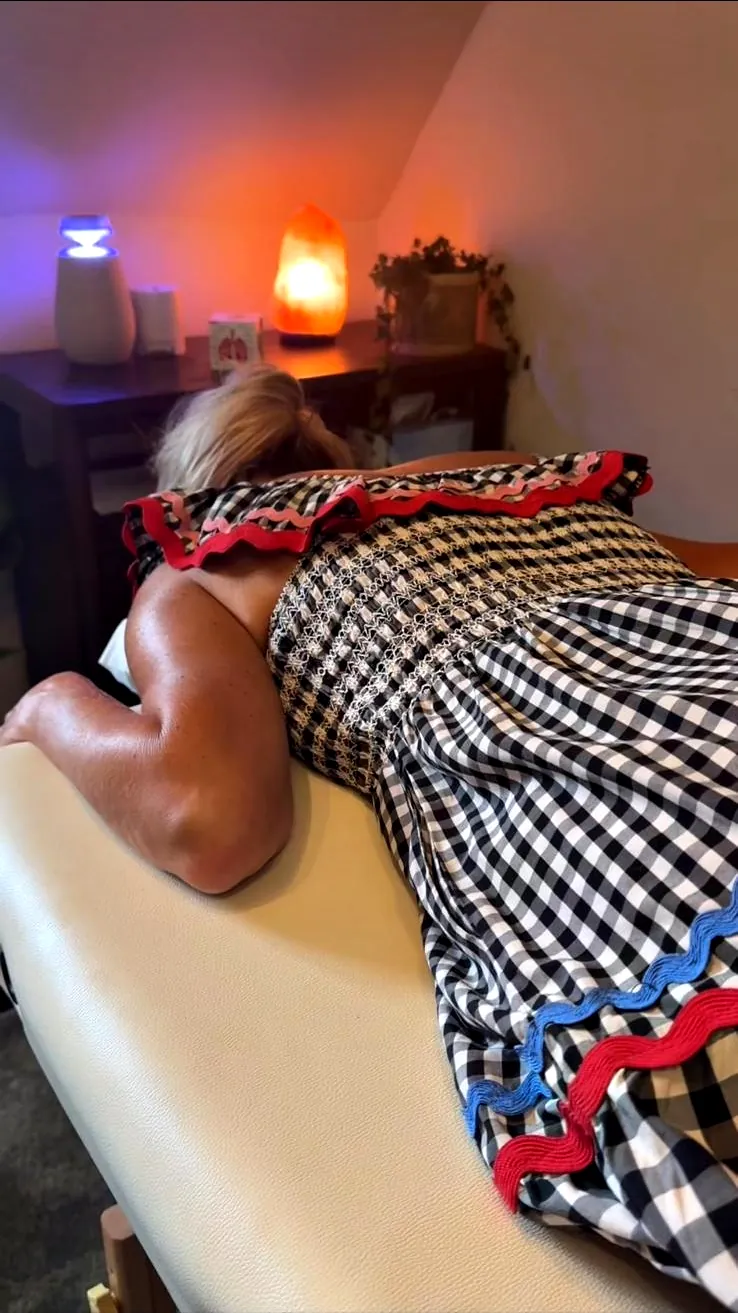 A client resting face down on the couch during a Spinal Flow session