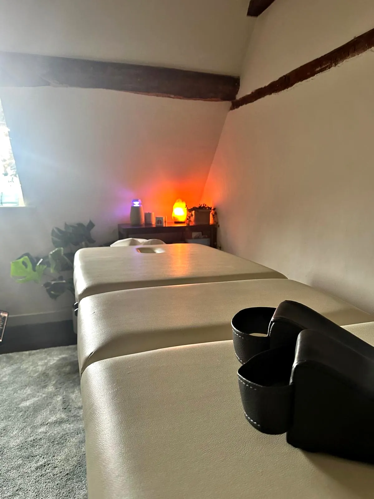 The couch and the armchair at The Brave Studio, the lamps glowing