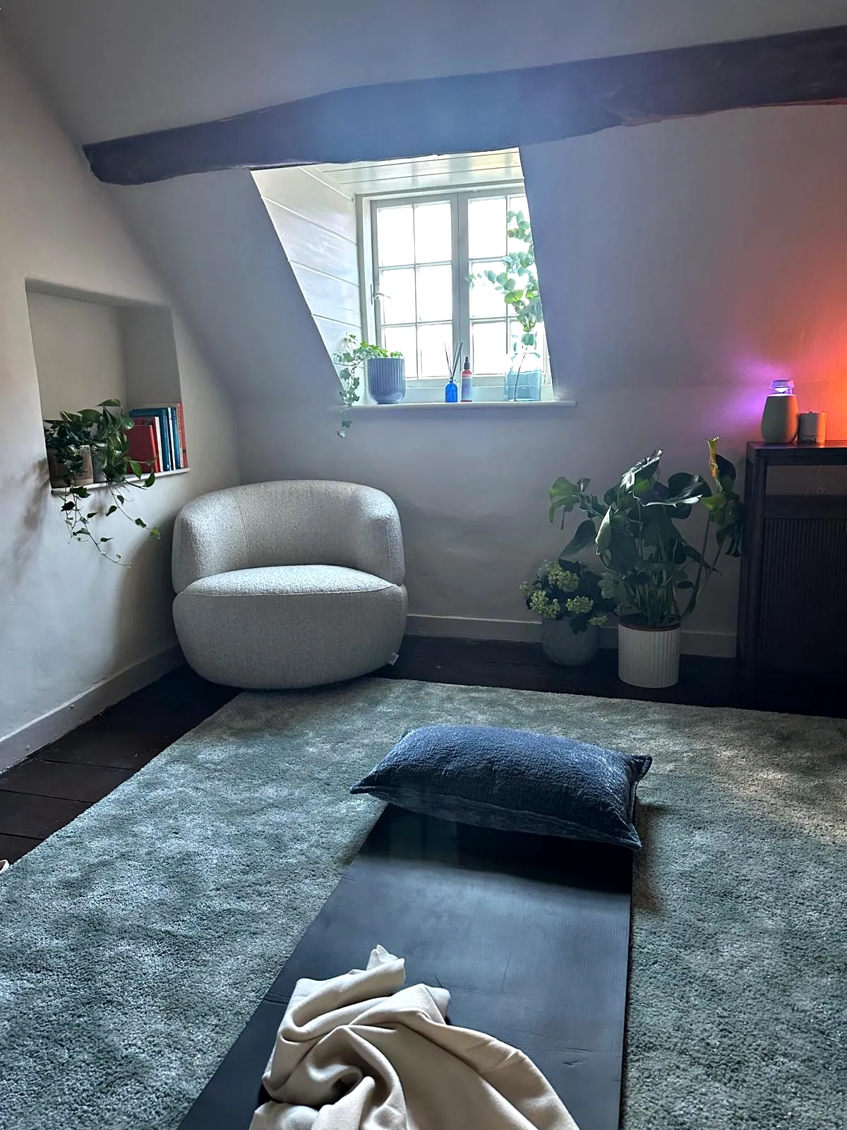A mat and cushion on the rug for a one to one breathwork session