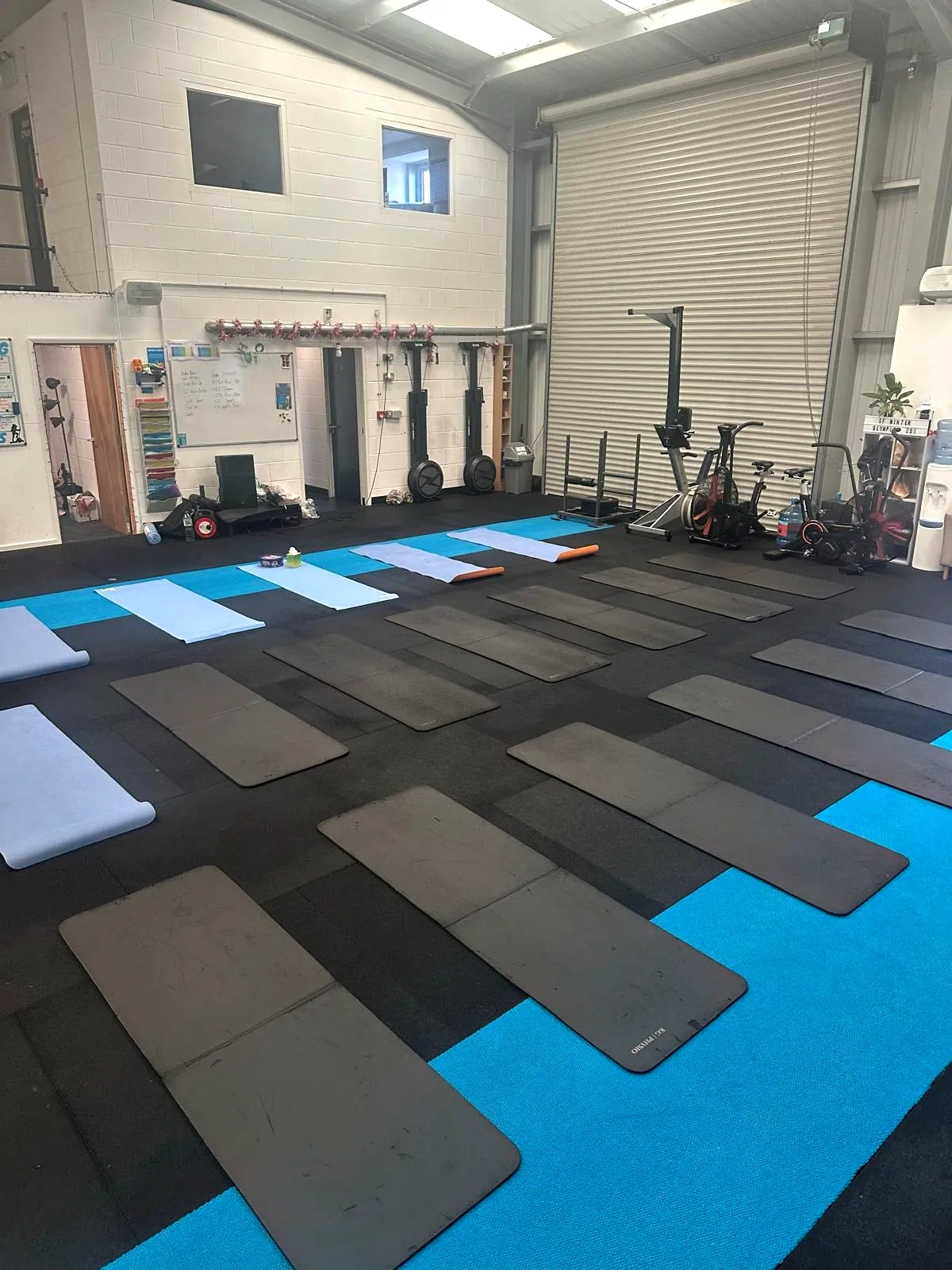 Rows of mats on a gym floor before a group session